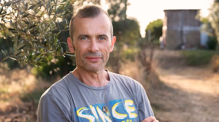 Portrait photo of Andrea stood outside. Andrea has multiple sclerosis and uses Peristeen Plus to manage his bowel issues.
